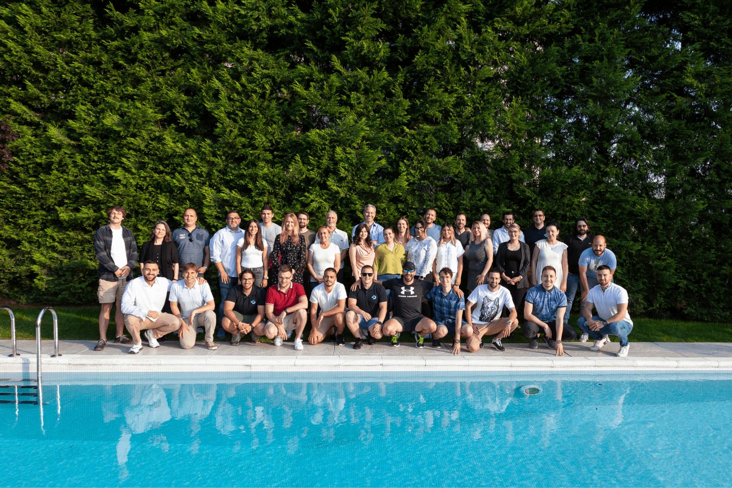 About Us - Team photo by the pool
